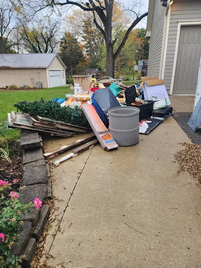 Dumpster being loaded with debris for Commercial Dumpster Rental in Carrollton